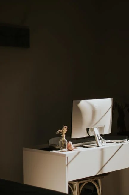 Minimalist desk with a focus on a multipurpose cleaner, office supplies, and storage solutions.